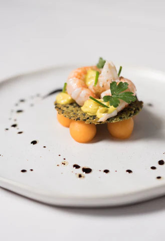 Langoustines met Galia meloen sesamkletskop en kerrie reductie